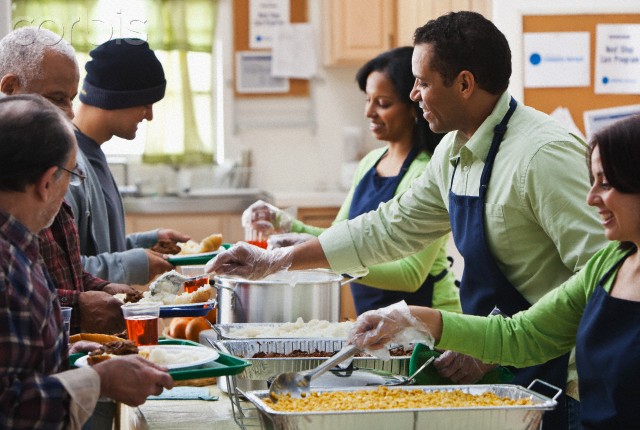 Volunteers serving in a soup kitchen